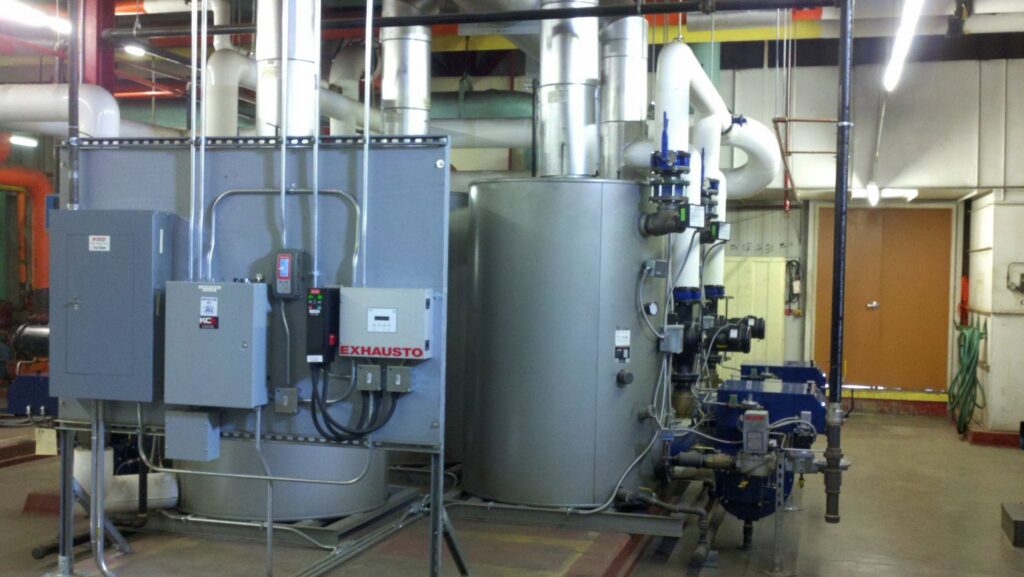 Large industrial boilers and associated piping in a mechanical room, serviced by KCM Heating & Air Conditioning in Omaha, NE.