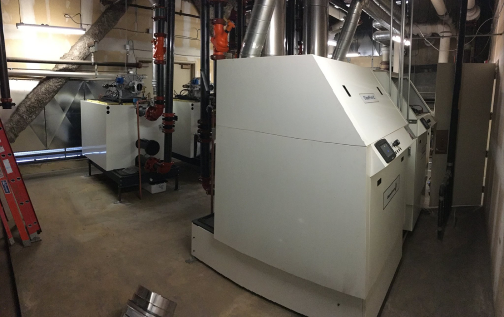 Industrial boilers and complex piping systems installed in a mechanical room by Holbrook Servco Boiler Service & Sales in Salt Lake City, UT.