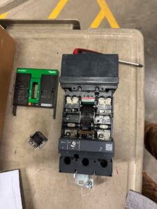 Close-up of an electrical component on an industrial compressor, showing repair work by Apex Electrical Solutions in Minot, ND.