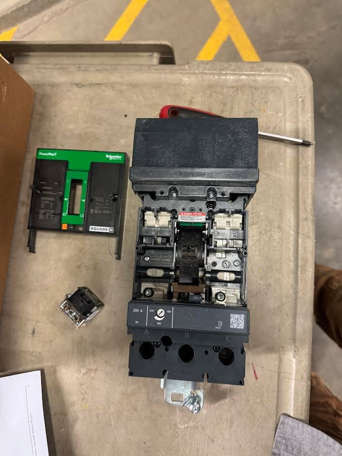 Close-up of an electrical component on an industrial compressor, showing repair work by Apex Electrical Solutions in Minot, ND.