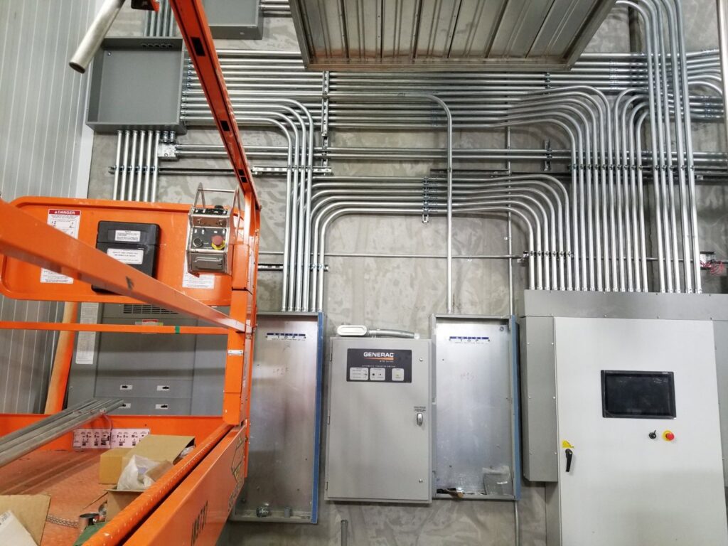 Industrial electrical installation with multiple conduits, junction boxes, and control panels by Access Electrical in Indianapolis, IN.