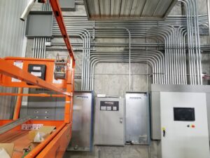 Industrial electrical installation with multiple conduits, junction boxes, and control panels by Access Electrical in Indianapolis, IN.