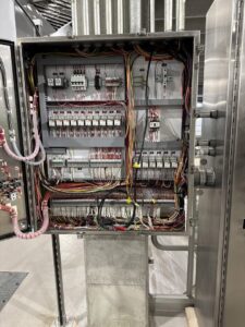 Complex wiring inside a large industrial electrical control cabinet by Apex Electrical Solutions in Minot, ND.
