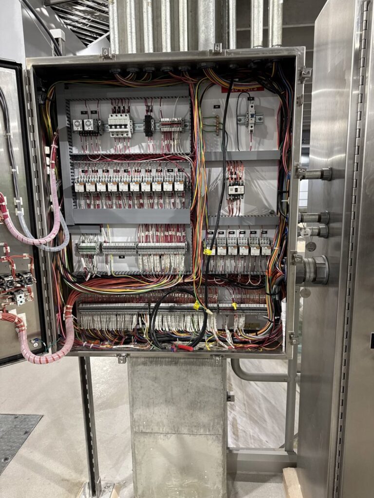 Complex wiring inside a large industrial electrical control cabinet by Apex Electrical Solutions in Minot, ND.