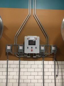 A newly installed industrial electrical control panel with conduit and wiring, completed by JJRS Electrical, LLC in Colorado Springs, CO.