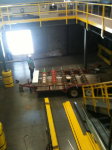 An industrial electrical job site with large cable spools and a worker, handled by AccuTex Electric in Fort Worth, TX.