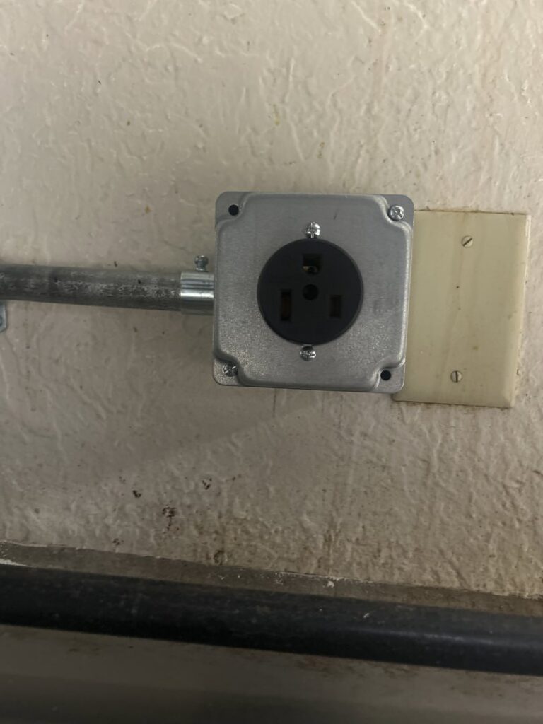 An industrial electrical outlet with metal conduit installed by LE Electric in Las Cruces, NM