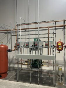 An industrial electrical panel installation with multiple conduits and control boxes by Wired Inc. in Lincoln, NE.