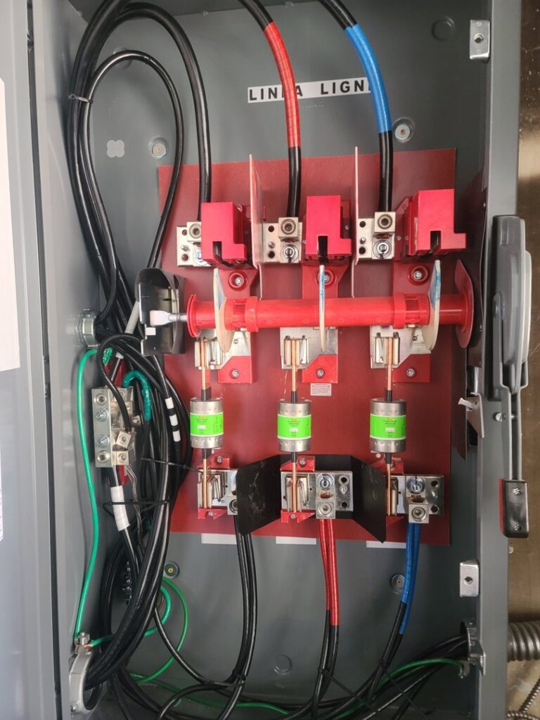 Interior view of an industrial electrical panel with fuses and wiring by TOTAL Electric LLC in Fayetteville, NC.