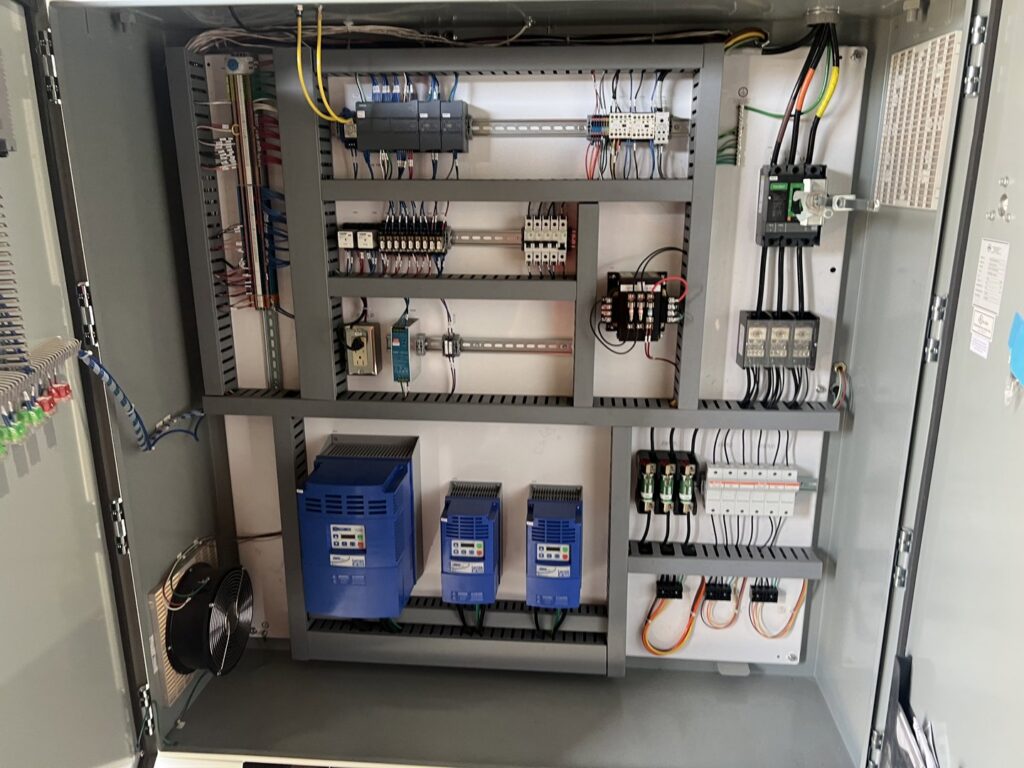 An industrial electrical control panel with complex wiring and components, expertly handled by Veritas Electric in Yalaha, FL.