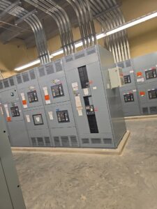 Large industrial electrical switchgear and panels installed in a commercial facility by Apex Electric LLC in Brea, CA.