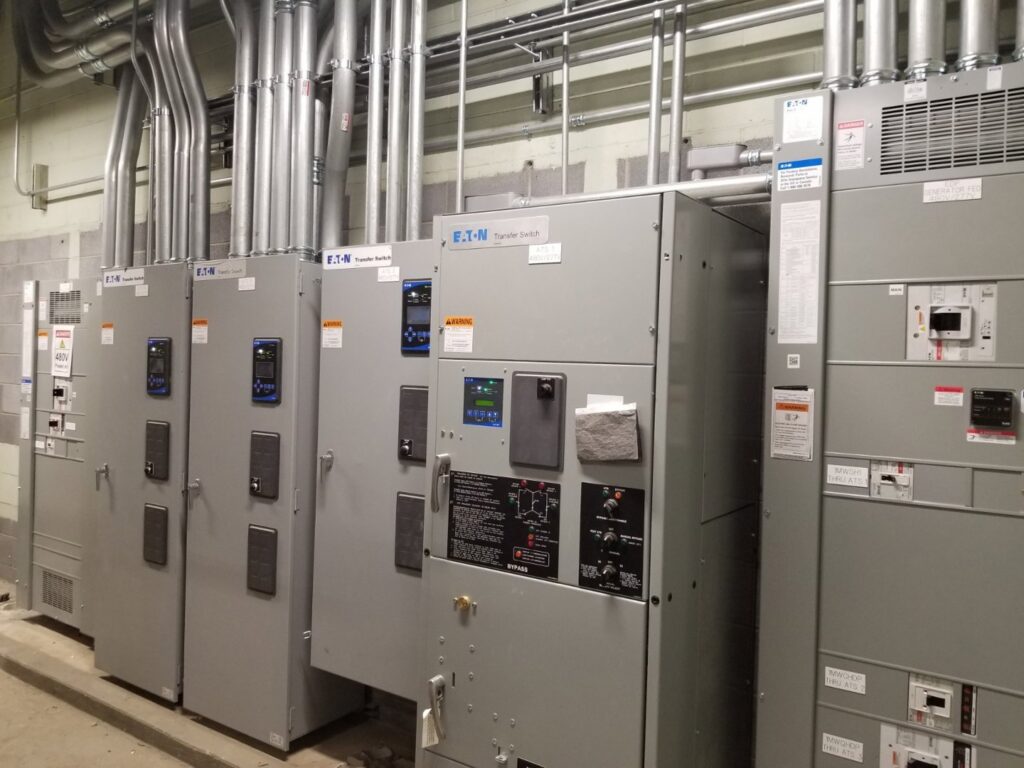 A row of industrial electrical transfer switches and panels installed by BESCO in Knoxville, TN.