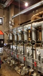 An industrial heating system with multiple units and complex piping, installed by Absolute HVAC in Wilmington, DE.