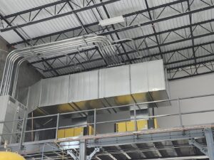 Large industrial HVAC ductwork and electrical conduits installed in a commercial building by SBS-NC, LLC in High Point, NC