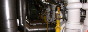 An intricate industrial HVAC piping system with valves and insulation, installed by Aero Mechanical Inc in Johnston, RI.