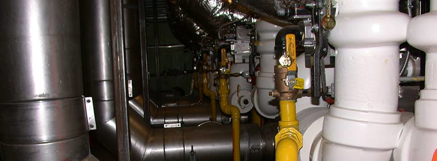 An intricate industrial HVAC piping system with valves and insulation, installed by Aero Mechanical Inc in Johnston, RI.