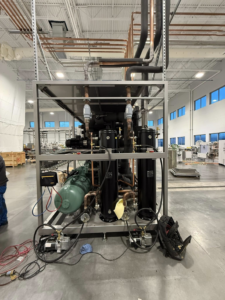 A large industrial HVAC refrigeration unit with copper piping and compressors being installed by KCC Mechanical, LLC in Sandy, UT.