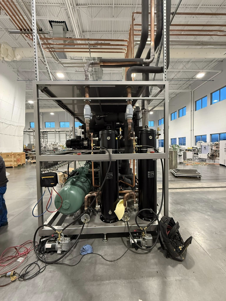 A large industrial HVAC refrigeration unit with copper piping and compressors being installed by KCC Mechanical, LLC in Sandy, UT.