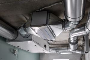 An industrial HVAC ventilation system with extensive ductwork installed on a ceiling by Climate Control in San Antonio, TX
