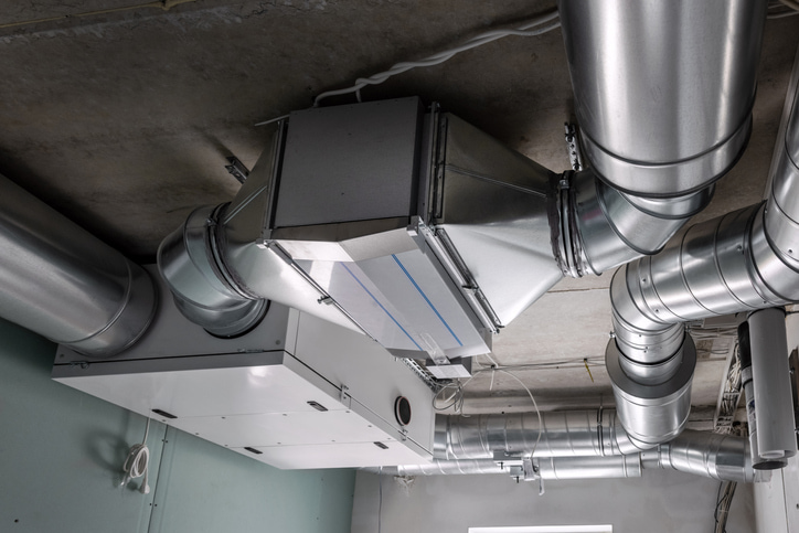 An industrial HVAC ventilation system with extensive ductwork installed on a ceiling by Climate Control in San Antonio, TX