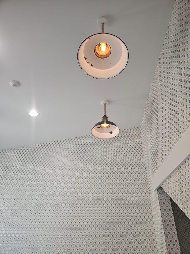 Industrial-style pendant lights installed on a ceiling by Powered Electrical & Lighting Services LLC in Springfield, MO.
