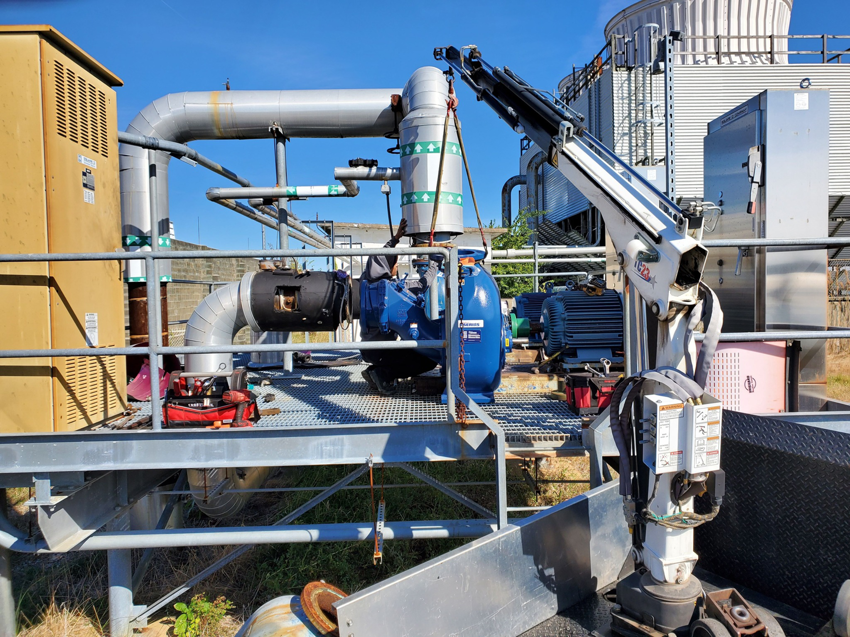 Industrial pump and motor installation or maintenance with a crane, performed by Caddell Electric Co Inc in Dallas, TX.
