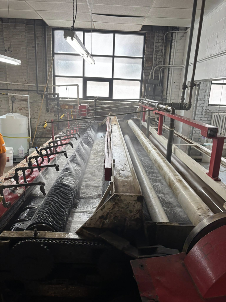 An industrial rug cleaning machine in operation at Harb's Carpeting & Oriental Rugs in Knoxville, TN