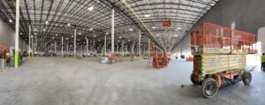 A vast industrial warehouse showcasing extensive overhead lighting installation by IBEW Local 24 Membership Development in Baltimore, MD.
