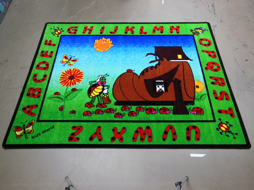 A fun insect and shoe-themed alphabet kids carpet by Conexxo Kids Carpets in Miami, FL.