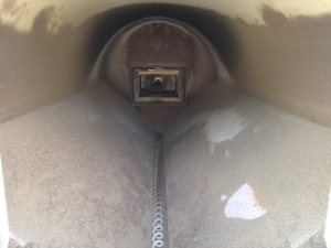 An inside view of a pellet boiler's auger system and combustion chamber, showcasing the technology used by Kedel Boilers in Portland, ME.