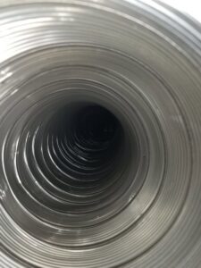 An inside view looking down a flexible metal chimney liner, installed by Colombus Chimney in Elizabeth, NJ.