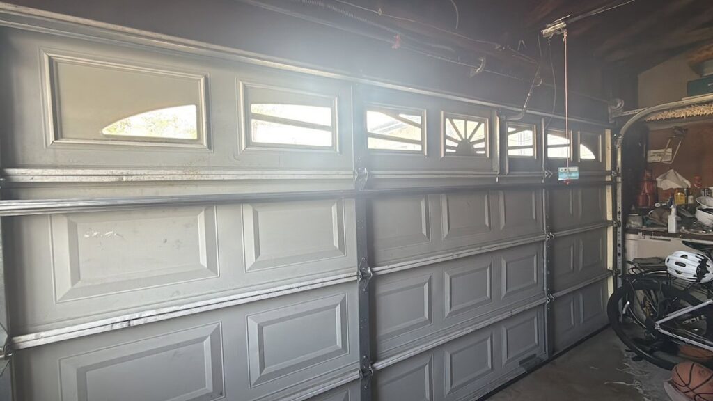 An inside view of a panel-style garage door, showing its structure, serviced by Baystate Garage Door in Milton, MA.