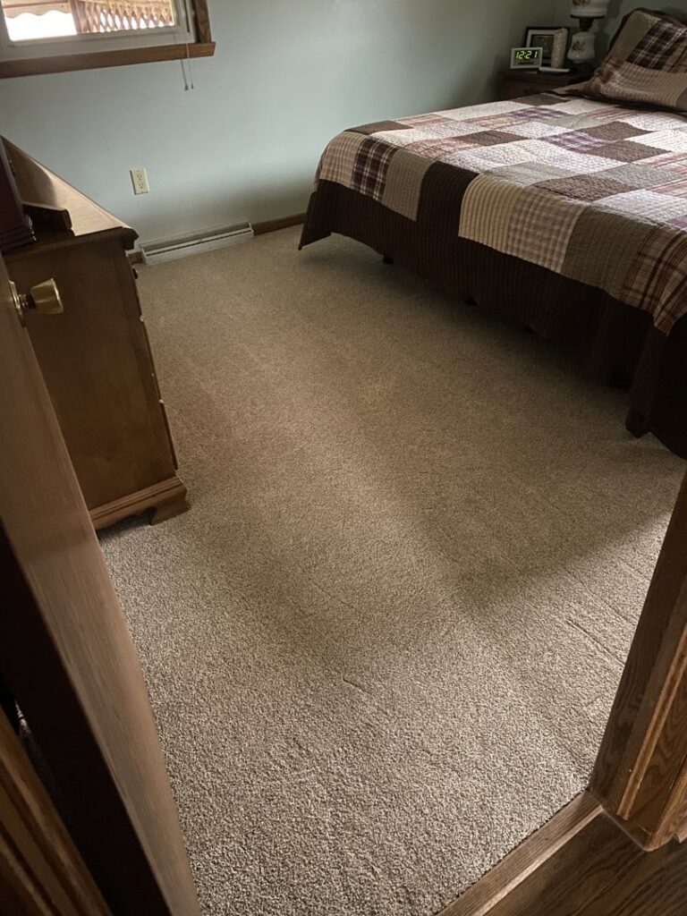 A newly installed carpet covering the floor of a bedroom by Lakefront Flooring in Erie, PA.