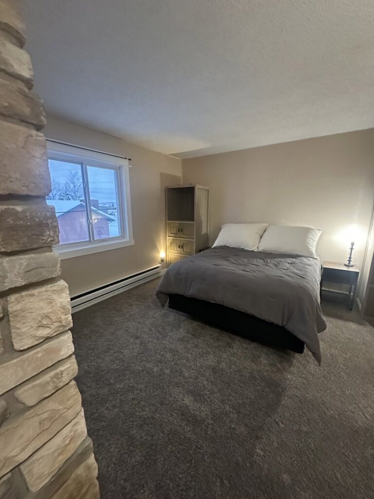 A bedroom with newly installed carpet by Pierce Carpet Mill Outlet in Bozeman, MT.