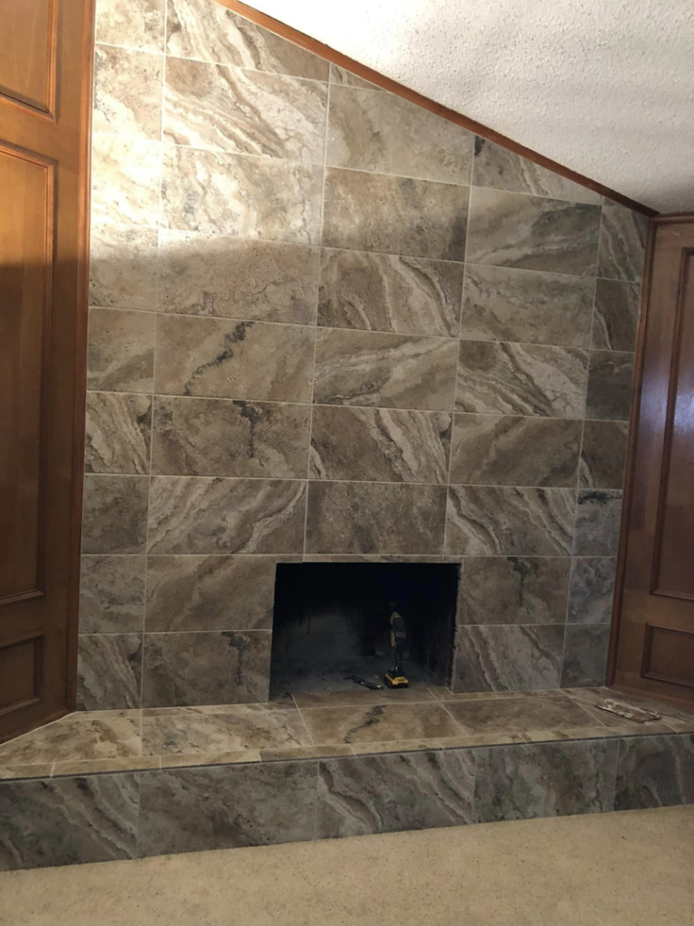 Newly installed carpet flooring in a living room with a fireplace by 3D Flooring & Design in Mansfield, TX