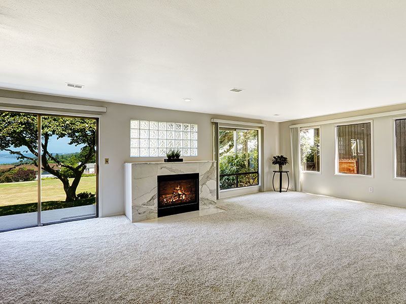 A beautifully installed light-colored carpet in a spacious living room by Premier Flooring in Fort Worth, TX.