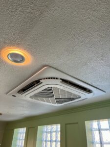 A modern ceiling cassette HVAC unit professionally installed by Just Heat Pumps in a Denver, CO home.