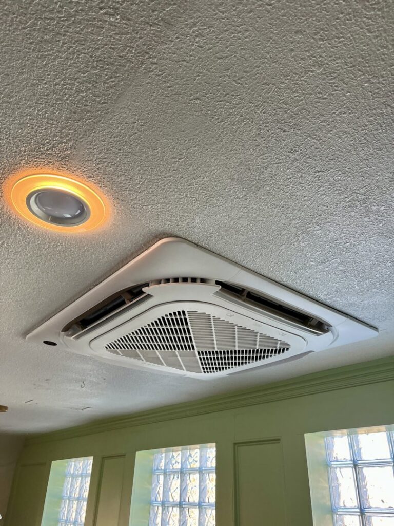 A modern ceiling cassette HVAC unit professionally installed by Just Heat Pumps in a Denver, CO home.