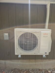 An outdoor Fujitsu Halcyon heat pump unit installed on the side of a house by Heat Pump Pros in Hartford, CT.