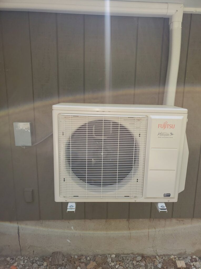 An outdoor Fujitsu Halcyon heat pump unit installed on the side of a house by Heat Pump Pros in Hartford, CT.