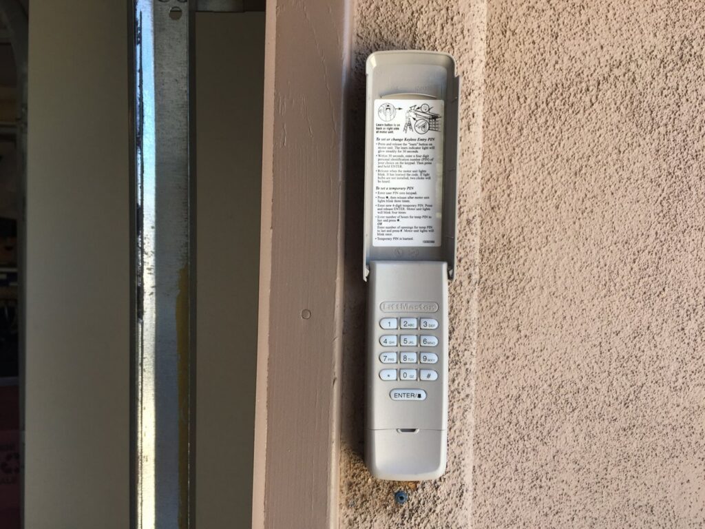 An installed garage door keypad on a wall by Nate's Garage Door Repair in Scottsdale, AZ.