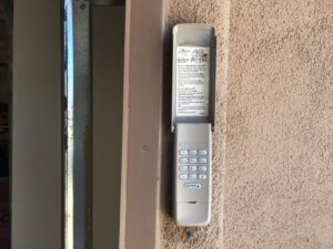 An installed garage door keypad on a wall by Nate's Garage Door Repair in Scottsdale, AZ.