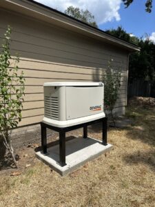 An installed Generac whole-home generator on an elevated stand next to a house by Never Without Power Generators LLC in Huffman, TX.