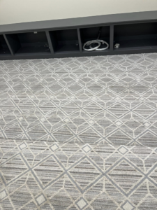 Newly installed geometric pattern carpet in a room by Flooring Liquidator in Orem, UT.