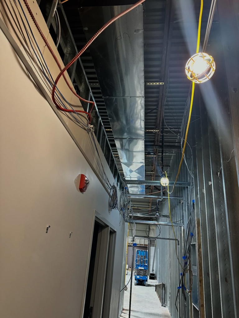 Newly installed HVAC ductwork running along the ceiling in a commercial building under construction by Magic Duct in Baltimore, MD