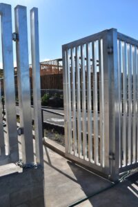 A newly installed large metal security gate for a commercial property by Upright Fencing Hawaii LLC in Kapolei, HI.