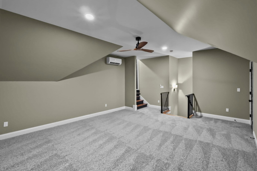 A spacious room featuring newly installed light gray carpet by Shop At Home Carpets in Bowling Green, KY.