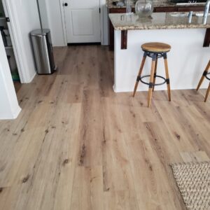 A kitchen area showcasing newly installed light wood-look flooring, a completed project by Anaheim Carpet and Flooring in Anaheim, CA.