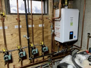 A newly installed tankless water heater and heating system by Blue Bear Plumbing, Heating, & Air in Norwell, MA.