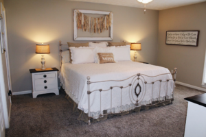 Newly installed wall-to-wall carpet in a cozy bedroom by The Carpet & Decorating Center in Phenix City, AL.